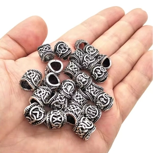 Set of Viking rune beard beads in antique silver finish held in hand to show scale