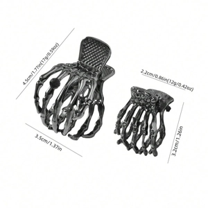 Macro shot of black metal skeleton hand hair claws showing sizes and glossy finish