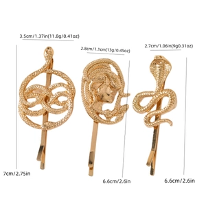 Three gold snake hair clips featuring Medusa head and cobra designs on a white backdrop
