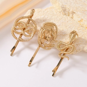 Three-piece gold alloy hair clip set featuring Medusa head and snake designs on stone