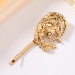 Golden Medusa head hair clip in vintage alloy design shown on clean white background