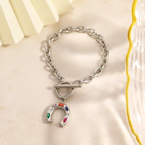 Stainless steel horseshoe bracelet with colorful zircon and toggle clasp on marble
