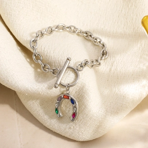 Detail of silver OT buckle bracelet with horseshoe pendant inlaid with colorful zircons