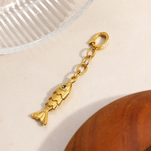 Gold stainless steel fish pendant with blue zircon eyes and sparkling stone clasp
