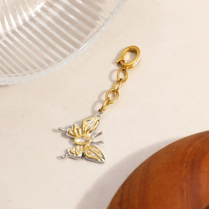Detail of a two-tone butterfly pendant in 18K gold and silver with crystal accent