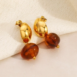 Vintage 18k gold plated drop earrings with brown resin beads on neutral textile background