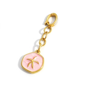 Macro view of gold starfish pendant with pink enamel and sparkling lobster clasp