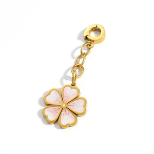 Detailed macro view of cherry blossom charm with pink gradient enamel and golden spring clasp