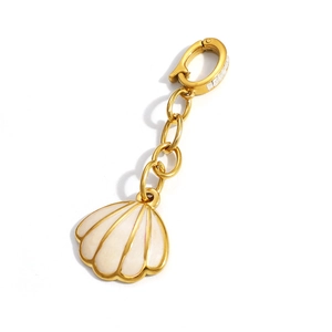 Detailed macro view of 18K gold plated seashell pendant with white enamel finish