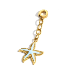 Detailed macro view of golden starfish charm with light blue enamel and textured edges