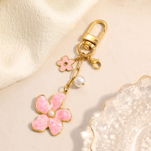 Close-up of pink flower charm with imitation pearl and 18K gold plated lobster clasp