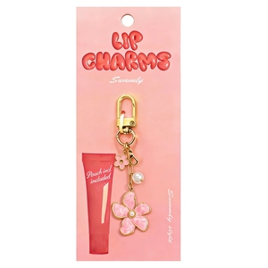 Detail of pink flower keychain with gold plating, pearl accent on brand display card
