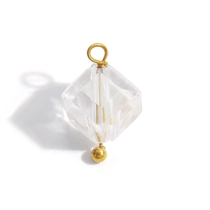 Detailed macro view of multifaceted clear crystal pendant with gold metal hardware finish