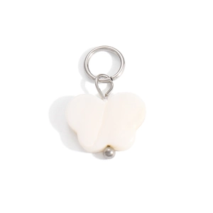 Detailed view of a white shell butterfly pendant with a silver metallic jump ring