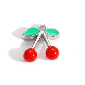 Detailed view of cherry pendant with red enamel fruit and green leaves on silver base