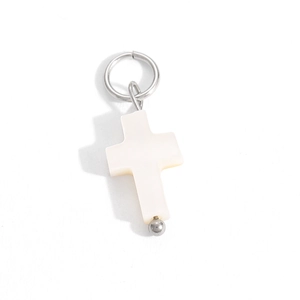 Detailed close-up of a white mother of pearl cross pendant with silver metal ring