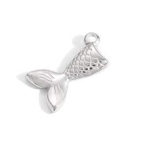 Detailed macro view of a silver mermaid tail pendant with intricate scale textures