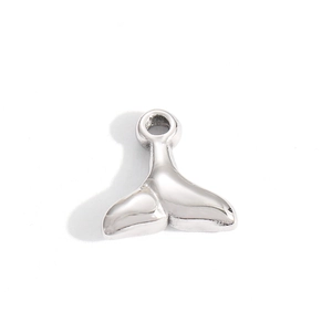 Detailed macro view of a polished silver whale tail pendant in stainless steel