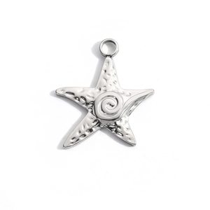 Detailed view of starfish pendant with hammered steel texture and spiral engraving