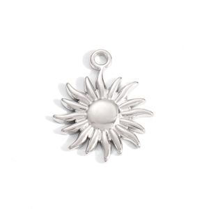 Detailed view of sun-shaped stainless steel pendant with polished finish and radial texture