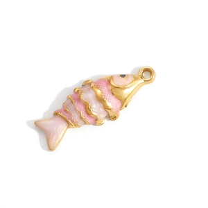 Detail of fish pendant charm with pink enamel scales and gold finish jewelry part