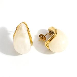 Detail of 18K gold plated teardrop earrings with cream resin inlay and push-back closure