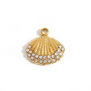 Macro detail of gold scallop shell pendant with sparkling rhinestones and textured finish