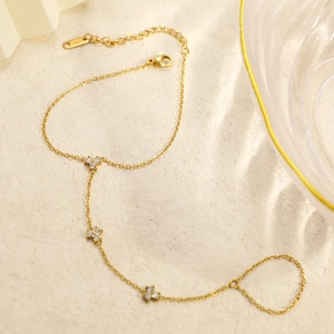 Detail of 18K gold-plated clover slave bracelet with sparkling white zircons