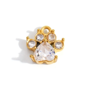 Close-up of a gold cat paw pendant with heart-shaped cubic zirconia and fine details