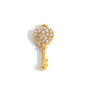 Macro shot of gold-plated heart-shaped key pendant with sparkling crystal inlay