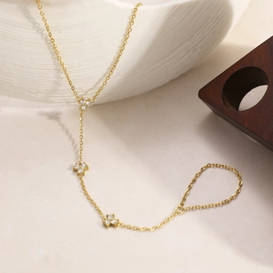 Close-up of 18K gold plated clover slave bracelet with sparkling crystal stones