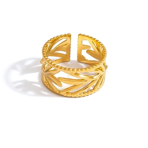 Close-up of golden stainless steel adjustable ring with hollow leaf pattern and beads