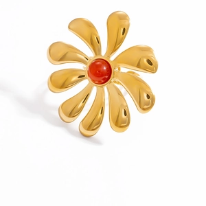 Detailed view of an 18k gold plated stainless steel flower ring with a red gemstone center