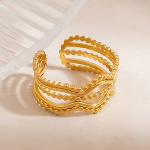 Detail of 18k gold plated stainless steel wave ring with delicate beaded textures