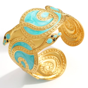 Snake wrap cuff bracelet with 18K gold plating and green enamel details on white background