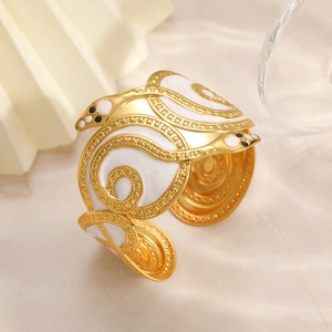 Detail of snake shape open bangle with white enamel inlay and gold plating finish