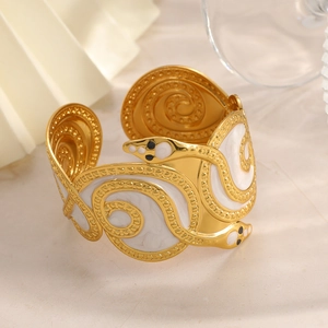 Elegant 18K gold snake wrap bracelet with white enamel marble texture and black eyes