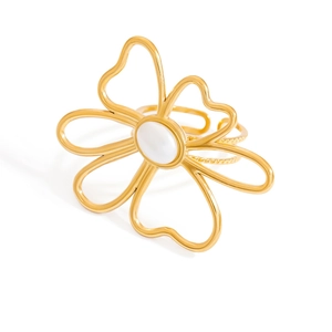 Exquisite hollow floral 18K gold plated ring with white stone center on white background