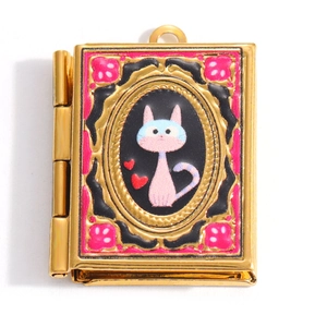 Macro detail of a vintage heart cat locket pendant with enamel finish and gold plating