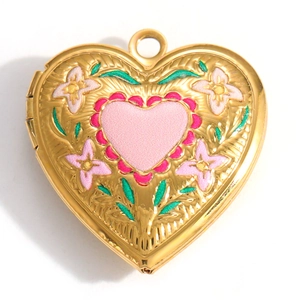Detail view of heart-shaped gold locket with pink floral enamel and embossed edges