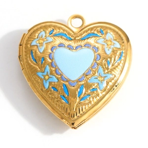 Detail of vintage golden heart locket pendant featuring blue floral enamel and hinge