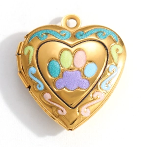 Macro shot of gold-plated heart locket pendant with cat paw print and floral enamel detail
