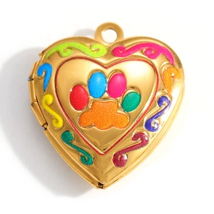 Detail view of a gold heart locket pendant with a colorful paw print and enamel vines