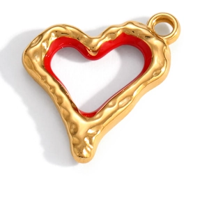 Macro detail of heart charm with red enamel and hammered gold-plated finish for jewelry DIY