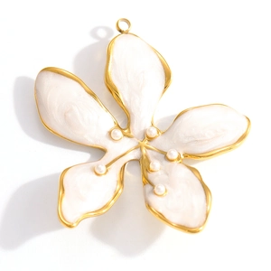 Macro detail of white enamel flower pendant with gold plating and pearl beads accents