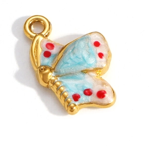 Detail of 18K gold plated butterfly pendant with blue enamel and red dot accents