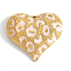 Detail of heart pendant with pink enamel leopard print and gold beaded edge detail