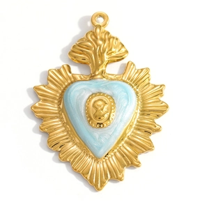 Macro view of sacred heart pendant with blue enamel and relief carving details