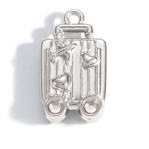 Close-up of silver suitcase pendant with airplane and heart details in polished steel
