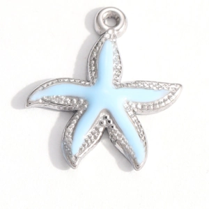 Macro detail of starfish pendant with light blue enamel inlay and textured silver finish
